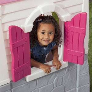 kind-kijkt-door-vensters-roze-speelhuis-step2-neat-tidy-cottage