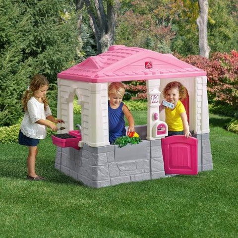 Image of kinderen-spelen-in-speelhuisje-step2-neat-tidy-cottage-roze-kinderhuisje